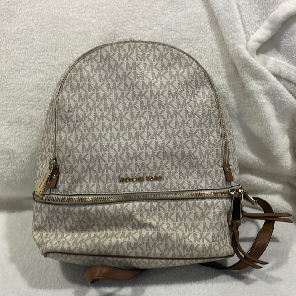 Tan and white Michael Kors backpack